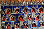 Myanmar, Burma, Nyaungshwe. Small Buddhas set into the temple wall, Shwe Yaunghwe Kyaung monastery, near Inle Lake. 